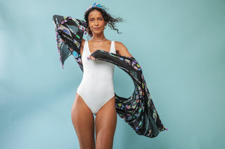 Model standing in front of light blue background wearing Sara Joy Sarong.