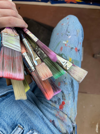 Paint brushes used to create a mural by New York muralist, Sara Joy.