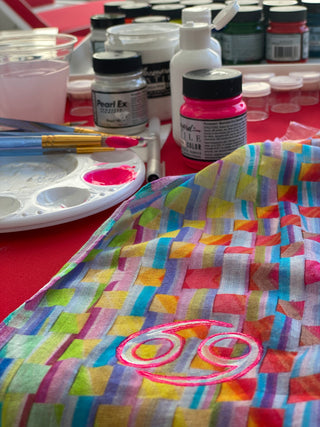 Sara Joy's set up while custom painting her resort wear.