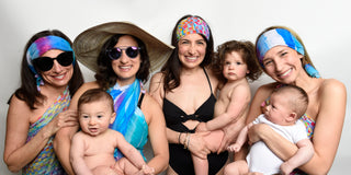 Sara posing with her sisters and their babies while wearing Sara Joy clothing items.