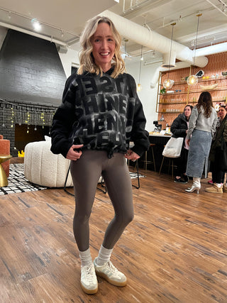 Woman modeling Sara Joy's custom painted sweatshirt.